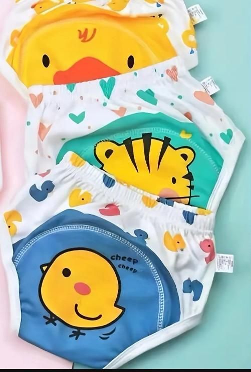 Set of children's underwear with cartoon duck, tiger, and chick designs on a light blue background.