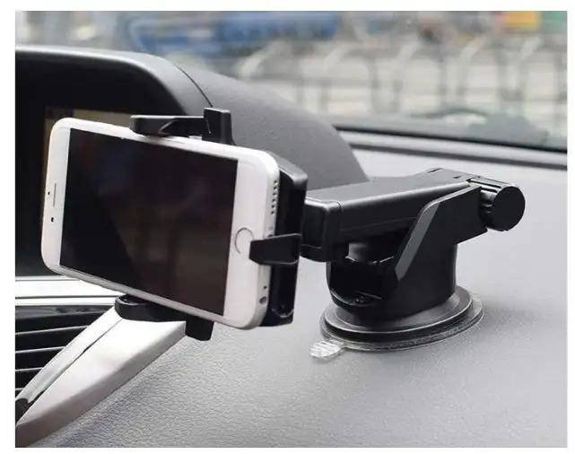 Phone holder on a car dashboard with a blurred background