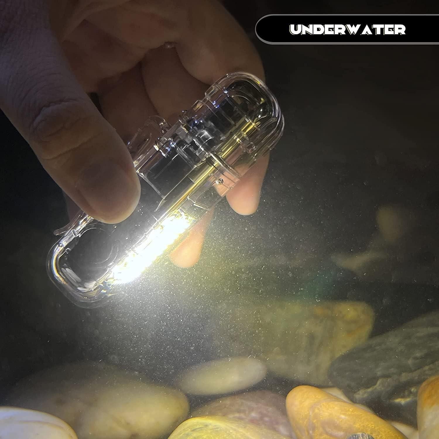 Hand holding a clear underwater light device with 'Underwater' text above, illuminating rocks and water.