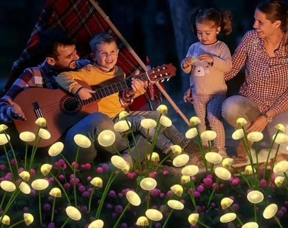 Family playing guitar in a field of glowing flowers at night
