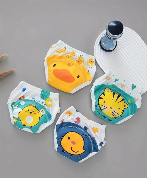 Four baby diapers with cartoon animal designs on a gray background