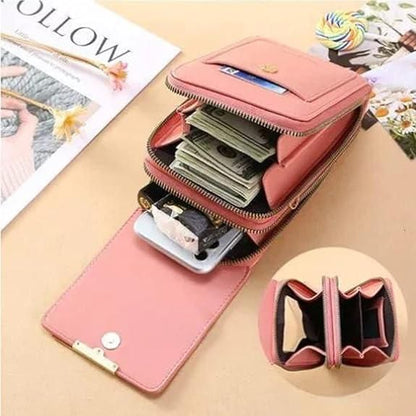 Pink wallet with compartments for money, cards, and a phone on a beige surface.